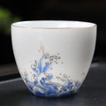 Minimalist Hand-Painted Dehua Suet White Porcelain Tea Cup - Blue Lotus Motif