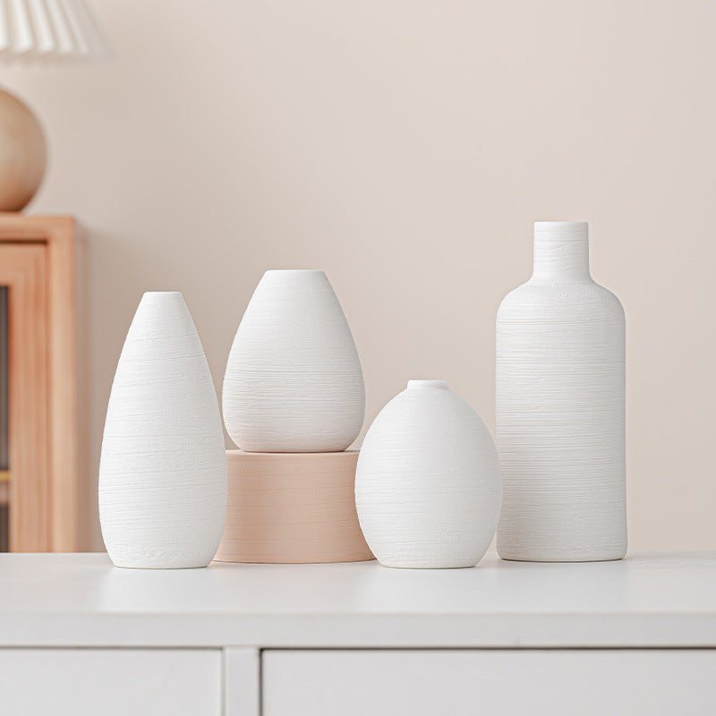 Set of five hand-thrown suet white porcelain bud vases - angle view